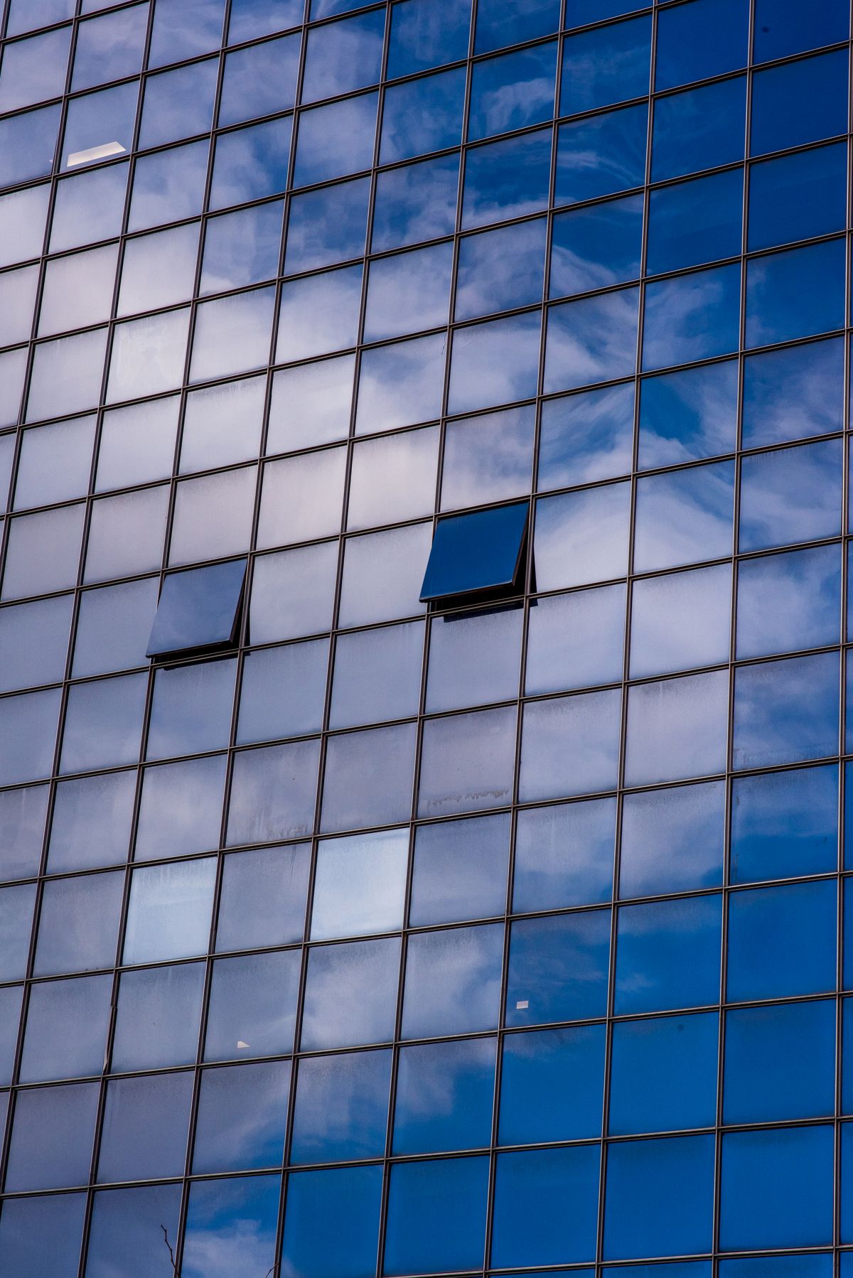 Glass facade reflecting the sky